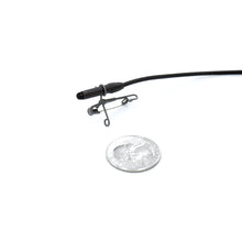 Small safety pin attached to black cable, shown next to a coin for scale