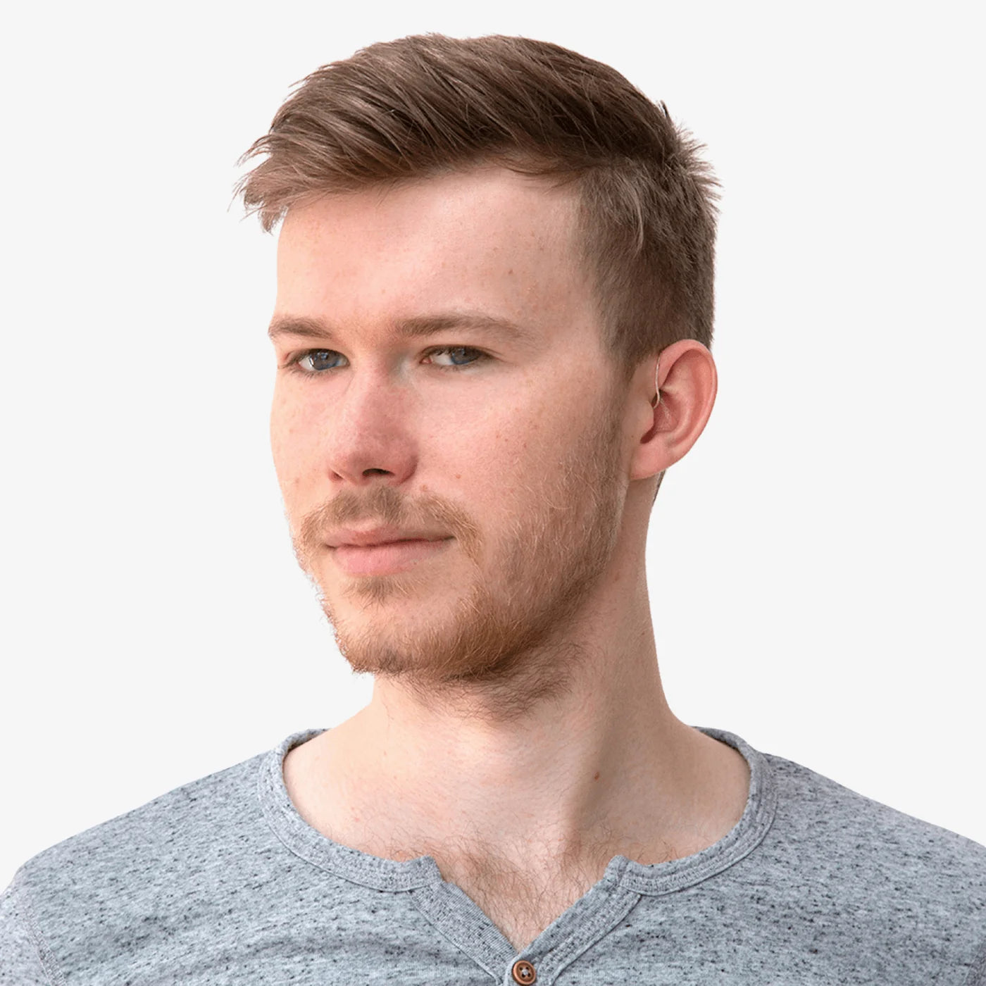 Person wearing an in-ear monitor with cable routed behind the neck