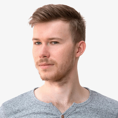 Person wearing an in-ear monitor with cable routed behind the neck
