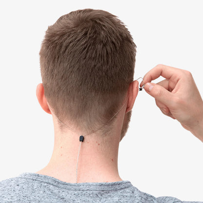 In-ear monitor earbud with cable routed along the neck, spare tip shown