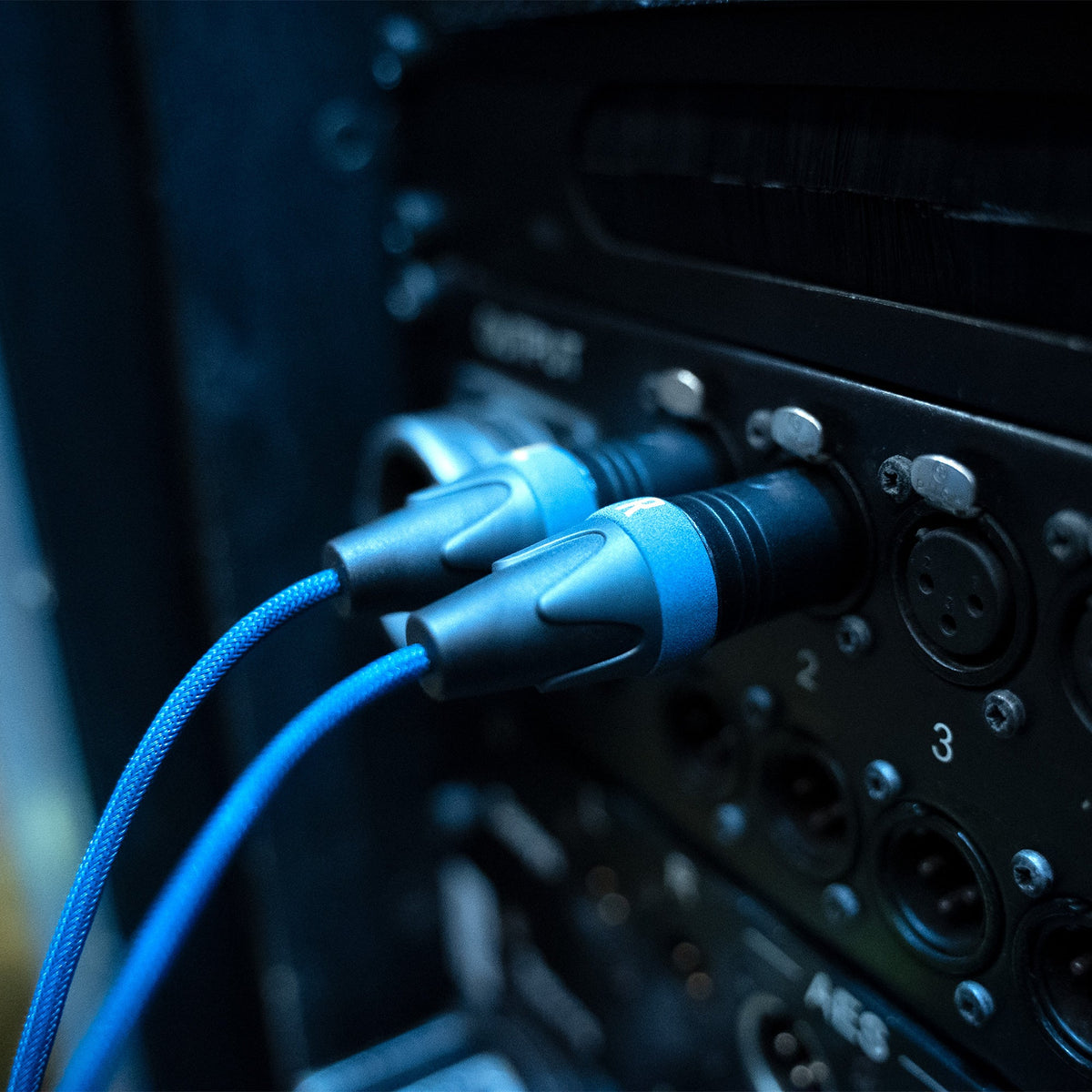 Blue braided USB-C audio cable with black connectors and glowing blue indicator rings