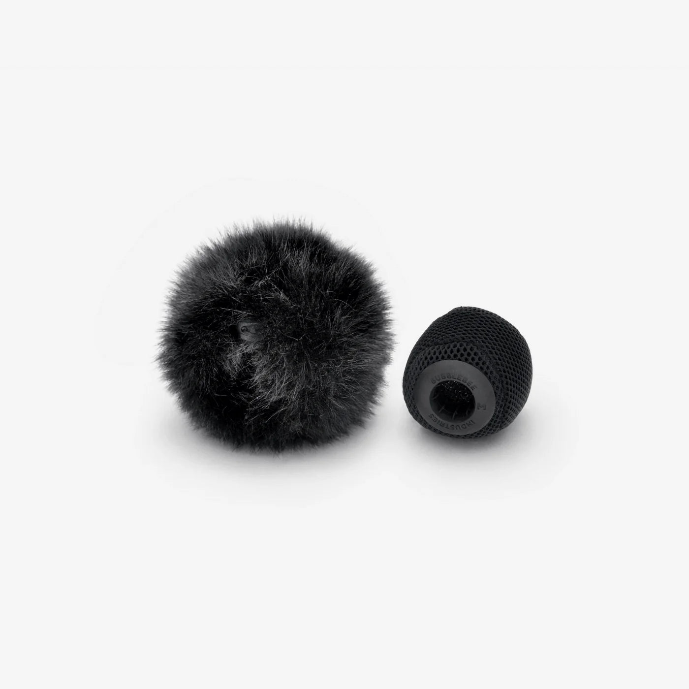 Black fuzzy ball and black mesh spacer ball shown side by side