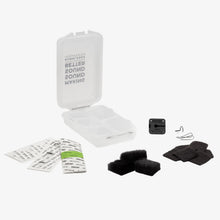 Mic hiding kit contents: clear case, black wind muff, pads, and small mounting parts