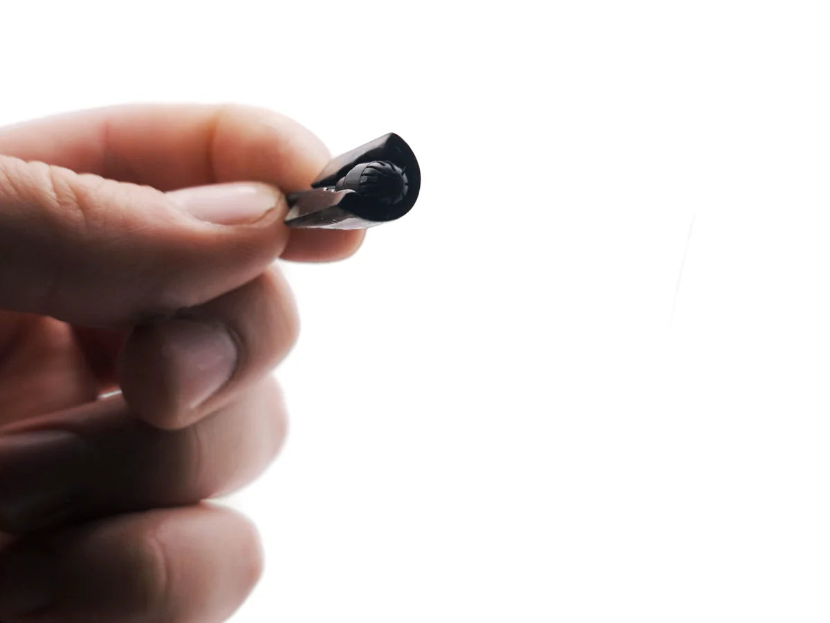 MiniMount microphone windscreen tip held in hand, small black foam piece