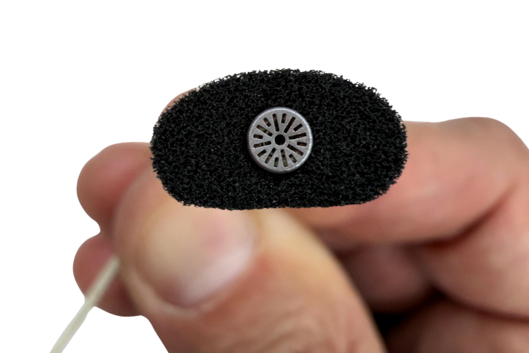 Close-up of a dark foam pad with a circular metal mesh insert
