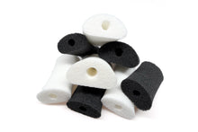 Mixed foam applicator pads in dark and white, each with a center hole