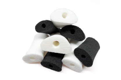 Mixed foam applicator pads in dark and white, each with a center hole