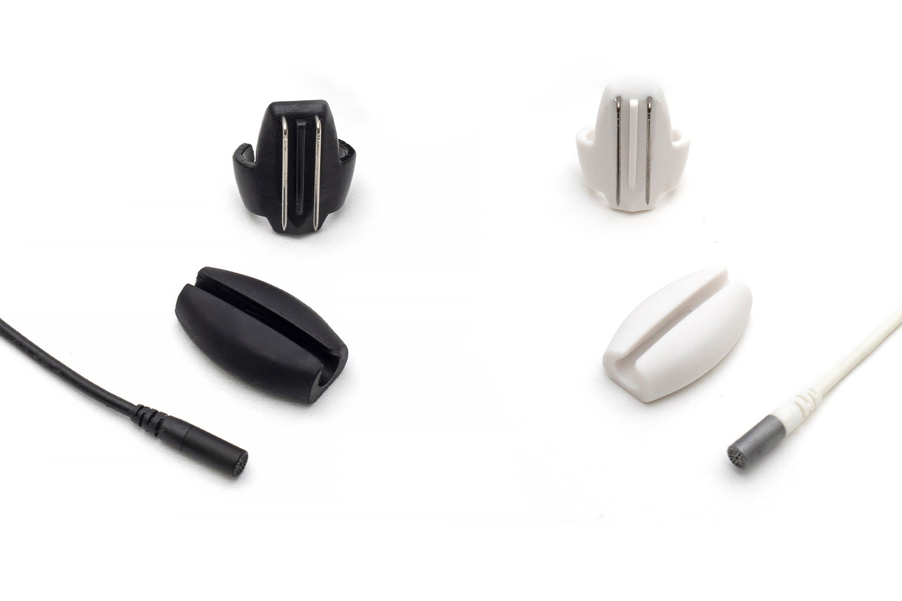 Black beetle-shaped clip with two silver metal prongs, angled view