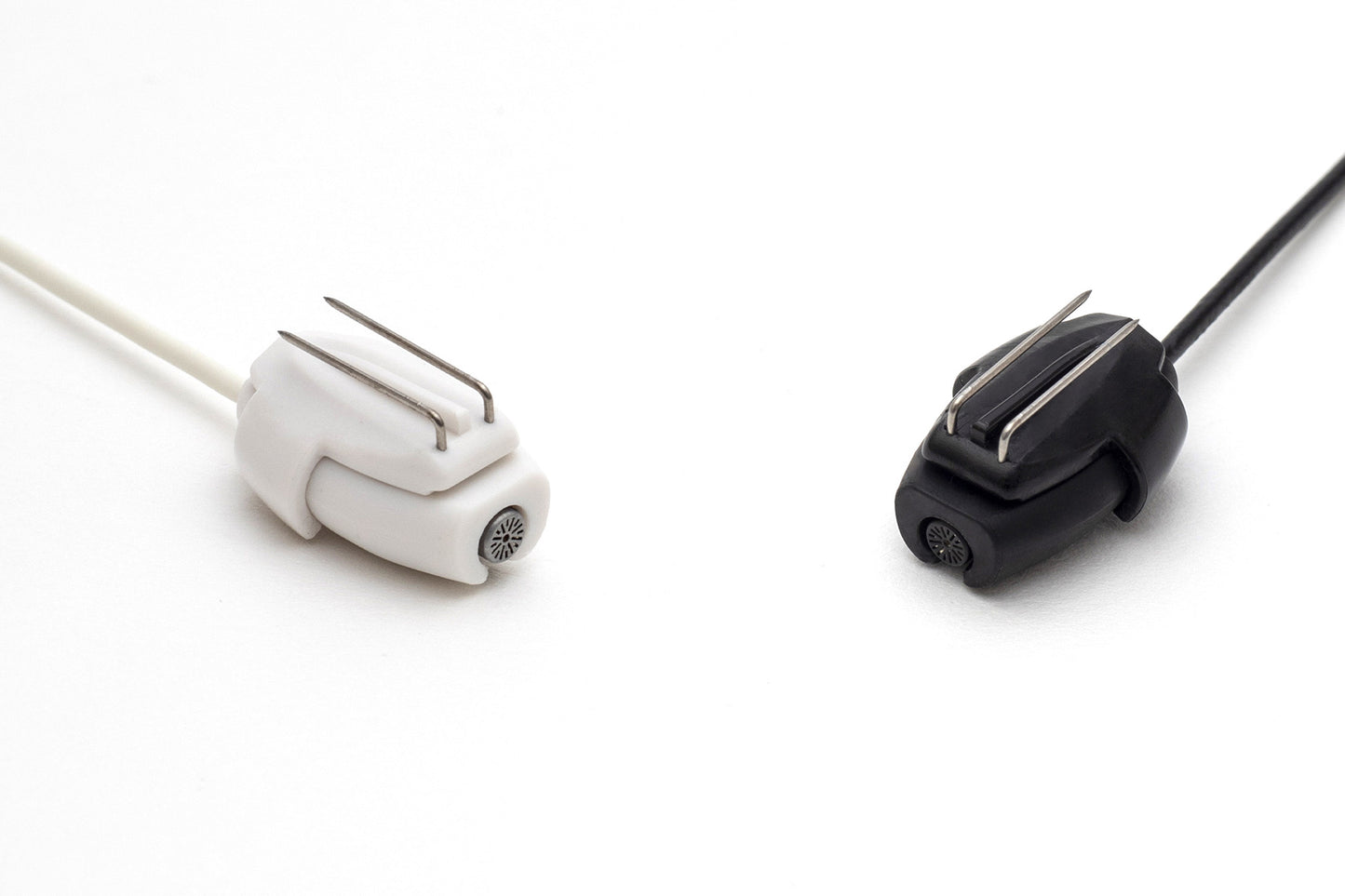 White and black beetle-shaped hair clips with two metal prongs and cords