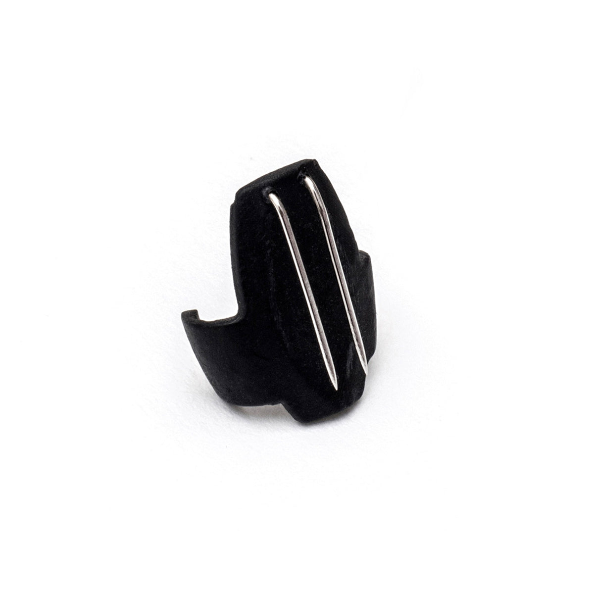 Black beetle-shaped clip with two silver metal prongs, close-up