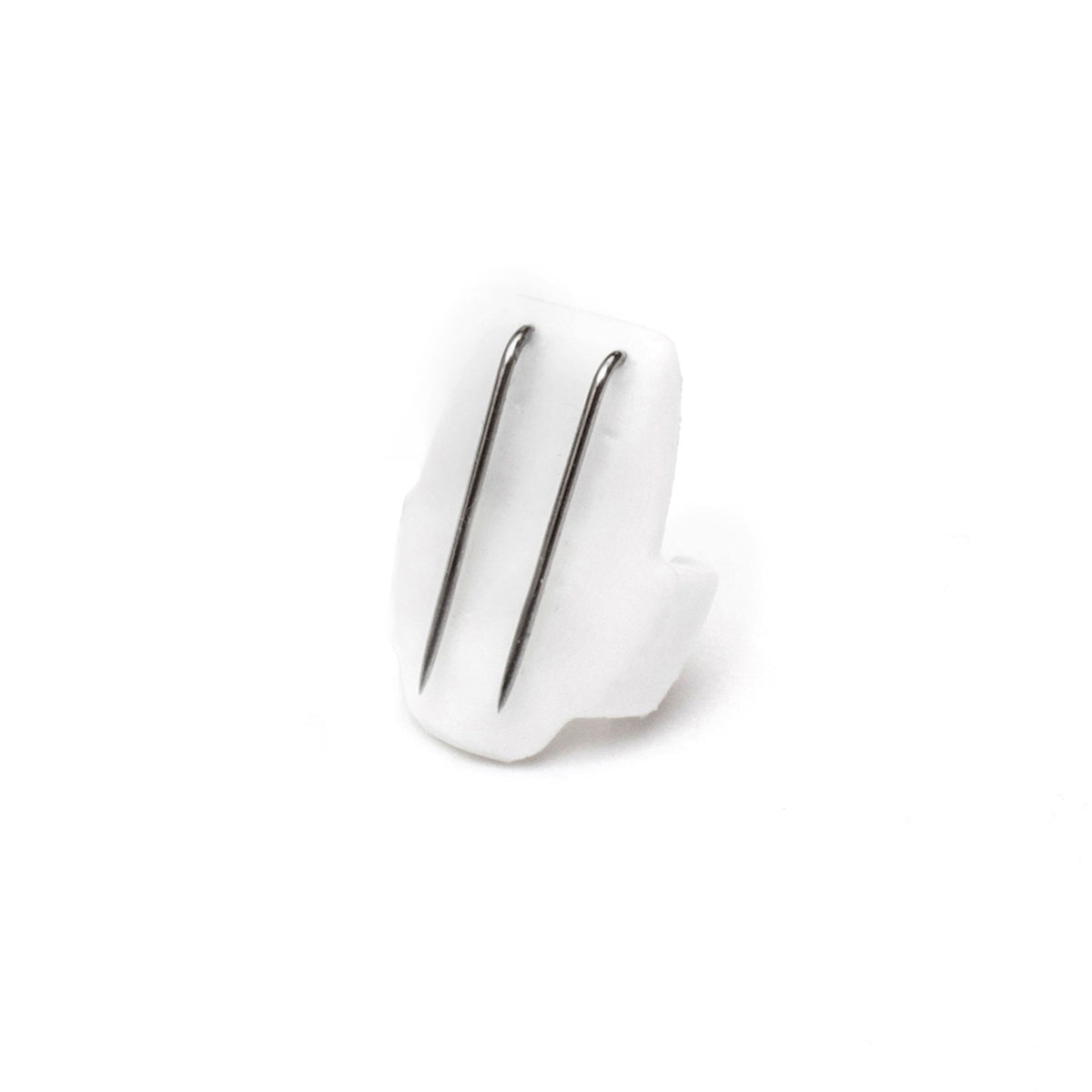 White beetle-shaped clip with two silver metal prongs, close-up