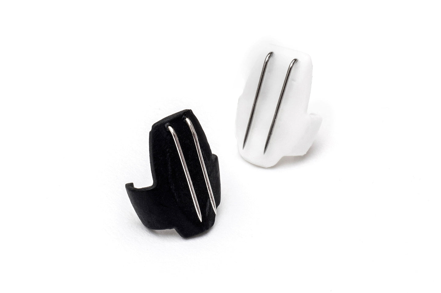 Black and white beetle-shaped hair clips, each with two silver metal prongs