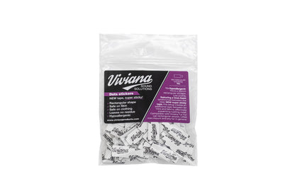 Bagged white dot stickers with black text, visible purple product label on front