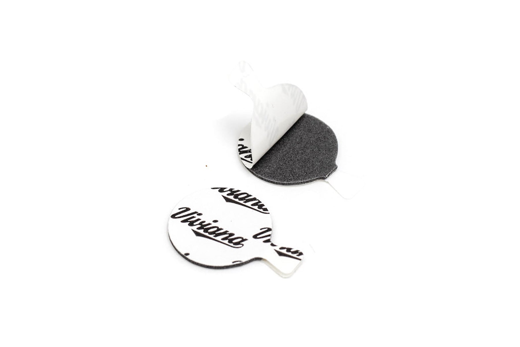 White backed adhesive dot stickers with black printed text, one peeled away