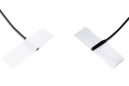 Moleskin Original adhesive patch strips on black cord, two crossed white tabs