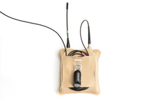 Beige belt pouch holding cables and a small connected device inside