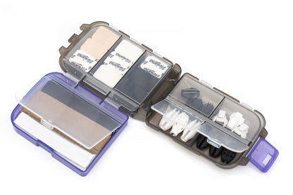 Clear accessory box open showing labeled inserts and white parts in compartments