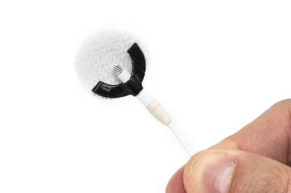 Sticker applicator with curved white foam tip and black segment, handheld