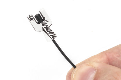 Sticker applicator handle with black foam brush tip and rectangular card backing