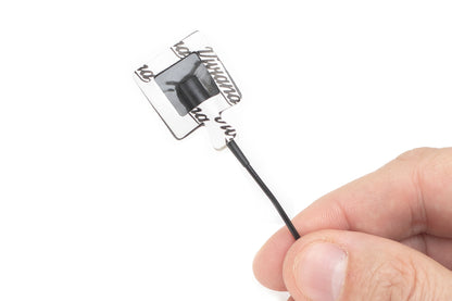 Sticker applicator with black foam brush tip and rectangular card backing