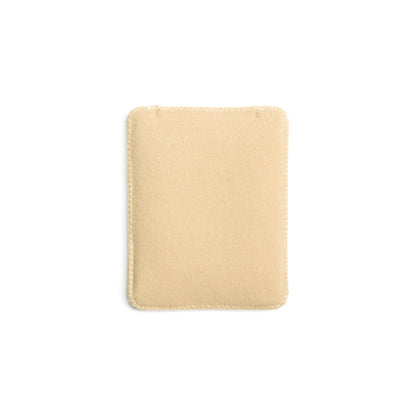 Light beige puffy pouch with rounded corners and stitched outer border