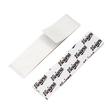 Double-sided white tape strips, overlapping thin rectangular pieces