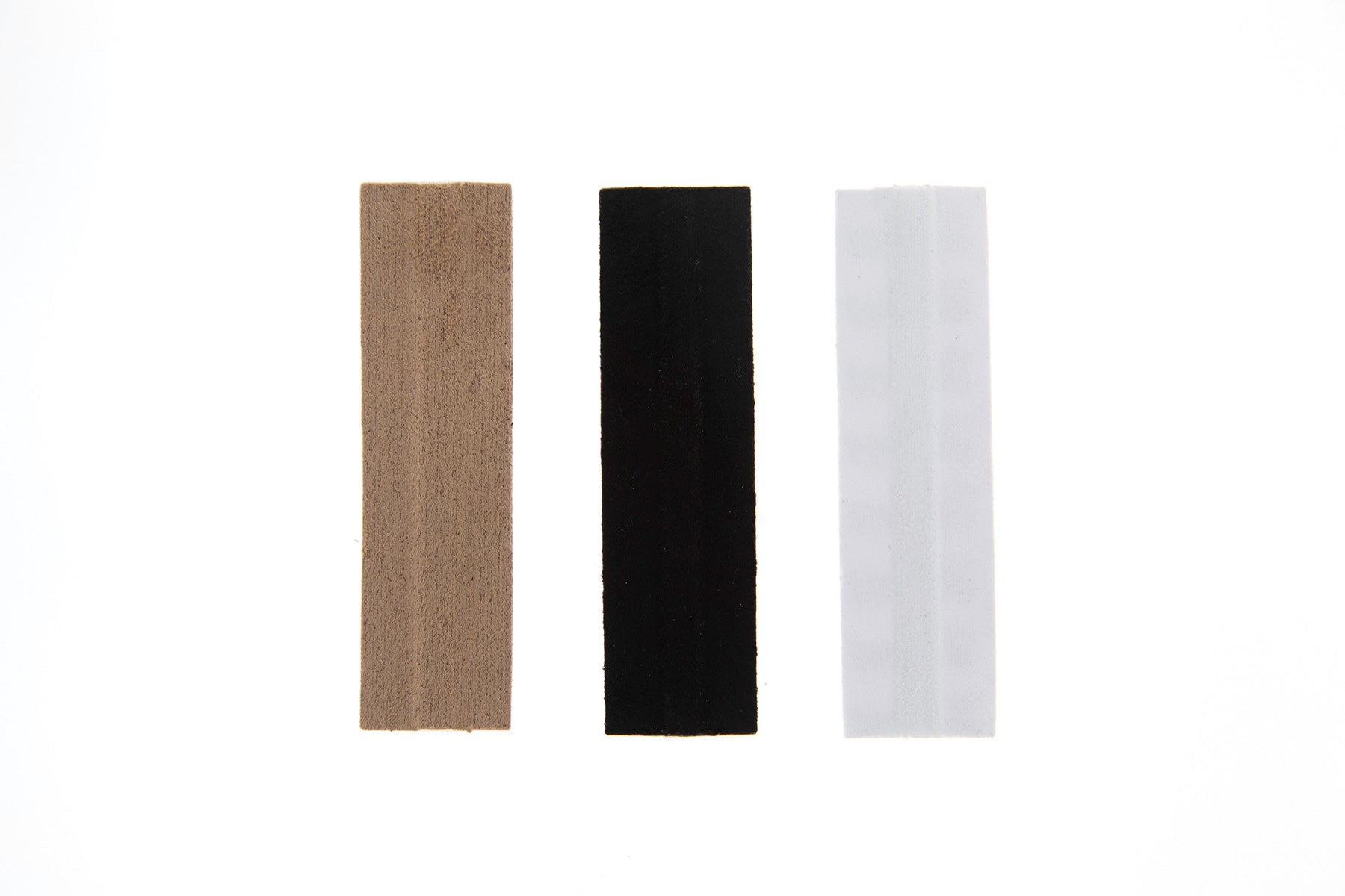Moleskin Extreme rectangular moleskin pads in beige, black, and white