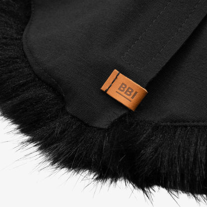 Black faux-fur microphone windscreen close-up with orange "BBI" label on fabric