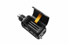 Wireless audio transmitter with open battery compartment and metal connector