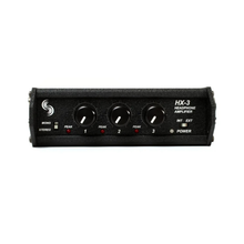 Black headphone amplifier with four knobs, power switch, and headphone output jacks