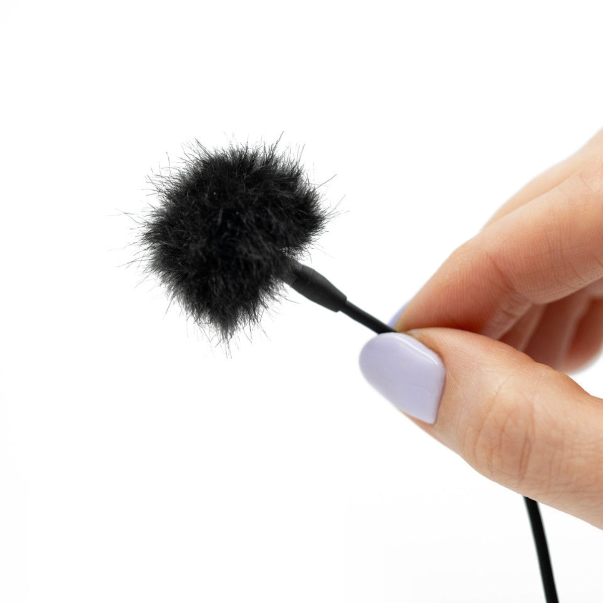 Black furry microphone windscreen cover on a cord, held by a hand