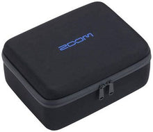 Black hard-shell carry case for accessories, zippered lid and zipper pull