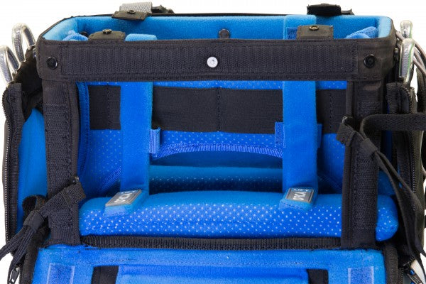 Audio mixer bag interior with blue dividers, mesh pockets, and padded compartments.