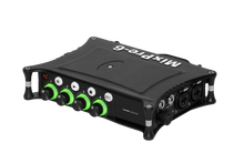 Black audio mixer/preamp with green control knobs and top panel switches