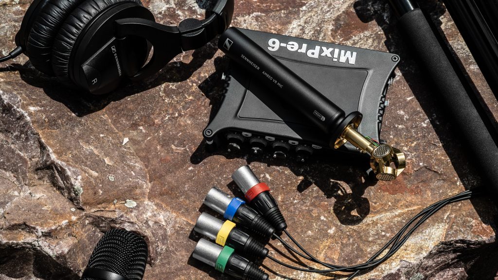 Audio mixer/preamp with microphone system and cables on a rocky surface