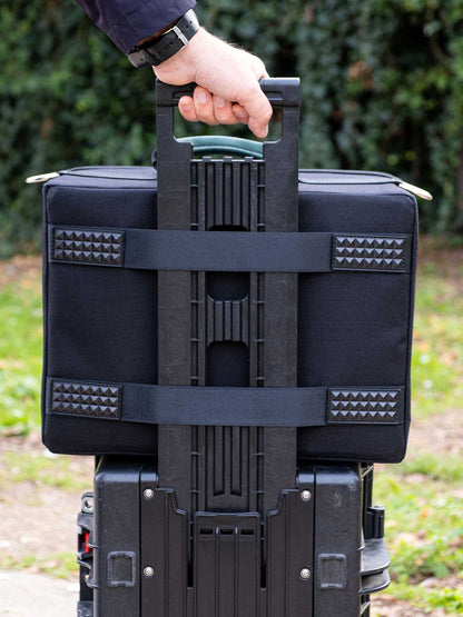 Black accessory organizer case with reinforced strap carry handle and webbing panels.