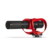 Black directional microphone barrel with perforated grille, red shock mount and cable output