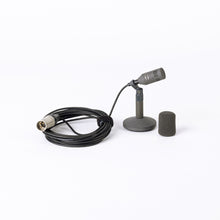 Compact cardioid microphone with cable, stand base, and black foam windscreen