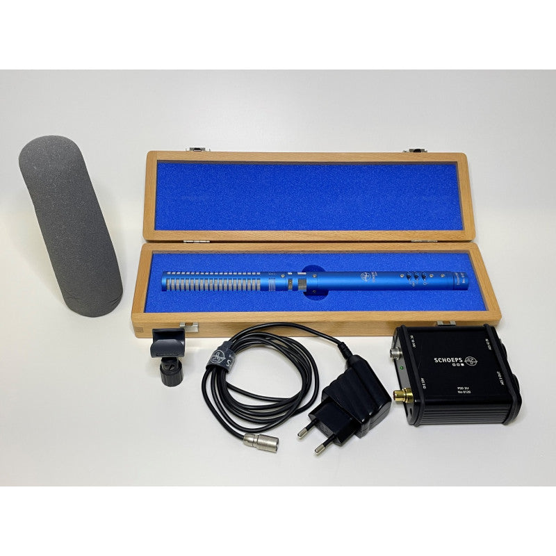 Digital shotgun microphone kit with wooden case, cables, power unit, and foam windscreen