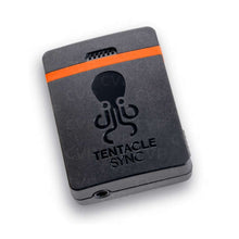 Dark gray timecode generator box with orange stripe and Tentacle Sync logo; side port