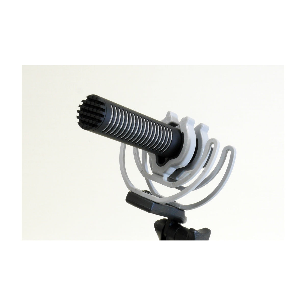 Shotgun mic with ribbed black grille on stand, silver mount