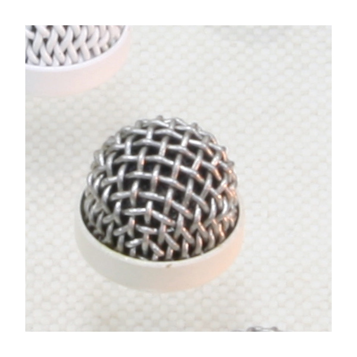 Metal microphone windshield with beige base and round wire mesh grille