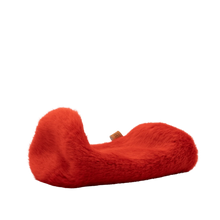 Red plush spacer cover with curved C shape and small fabric tag.