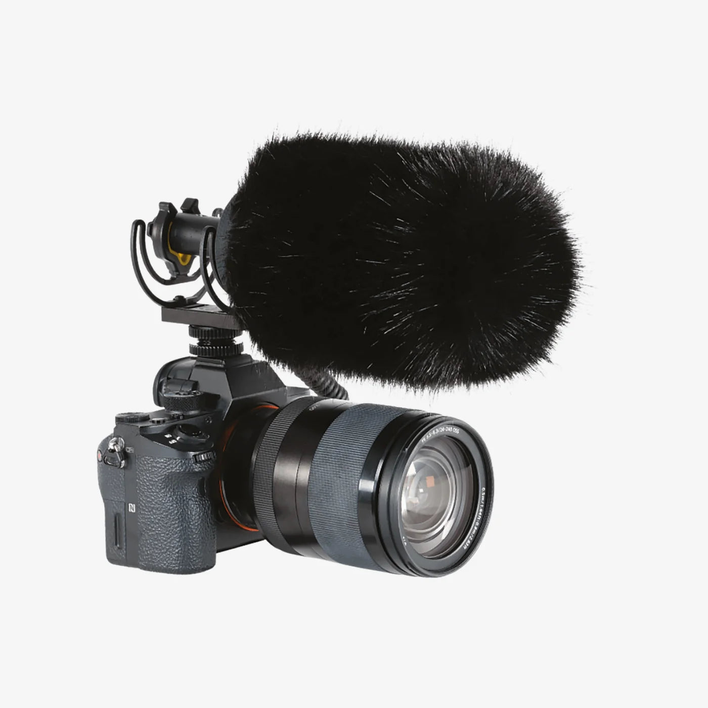 Black furry microphone windscreen on camera with zoom lens and mic mount