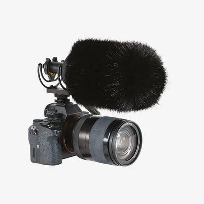 Black furry microphone windscreen on camera with zoom lens and mic mount