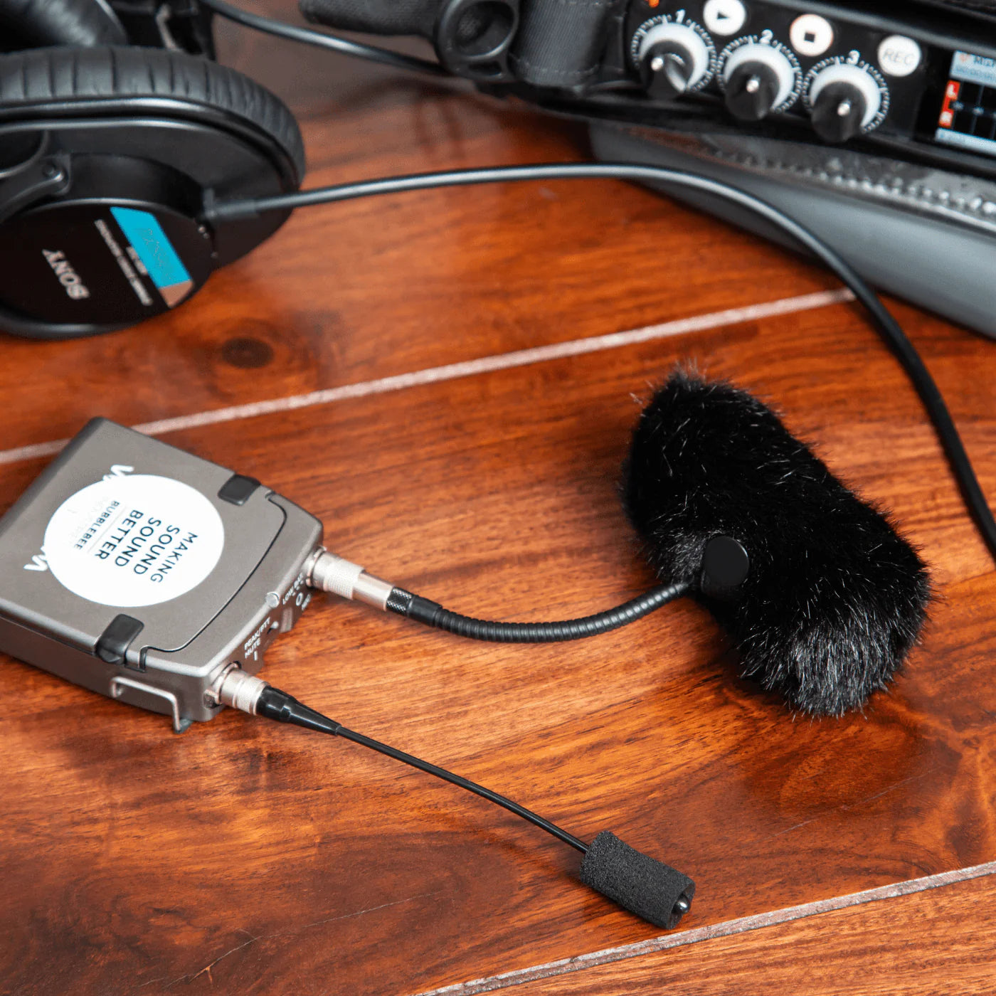 Black furry windscreen with attached cables for DPA microphone system