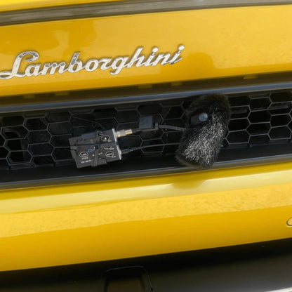 Black furry windscreen on a small microphone for DPA