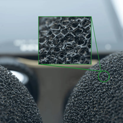 Black microphone windscreen with mesh grille and fur-covered surface