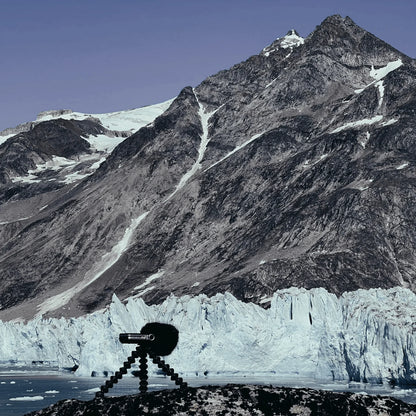 Small audio device on tripod with black furry windscreen
