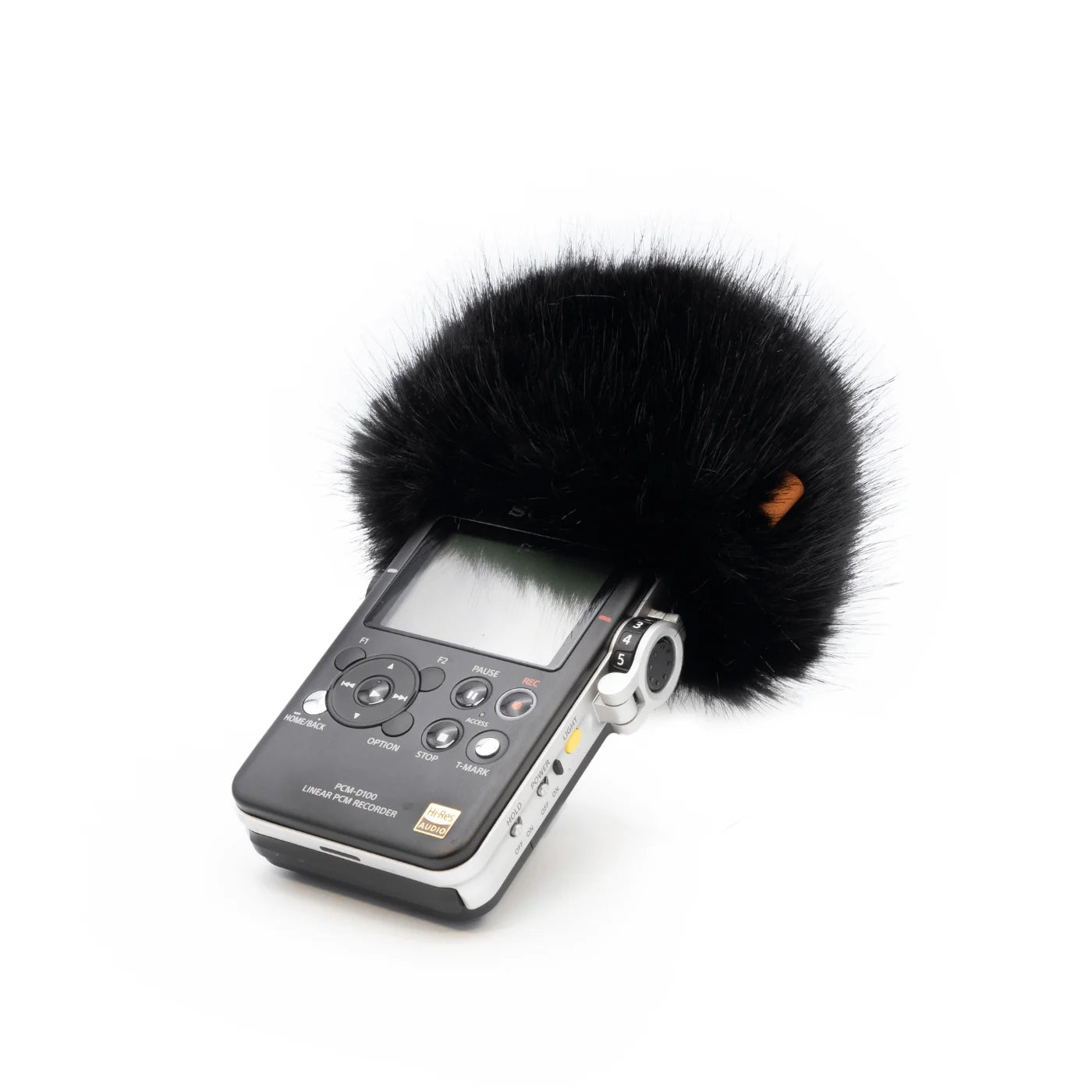 Handheld audio recorder with black furry windscreen and side controls